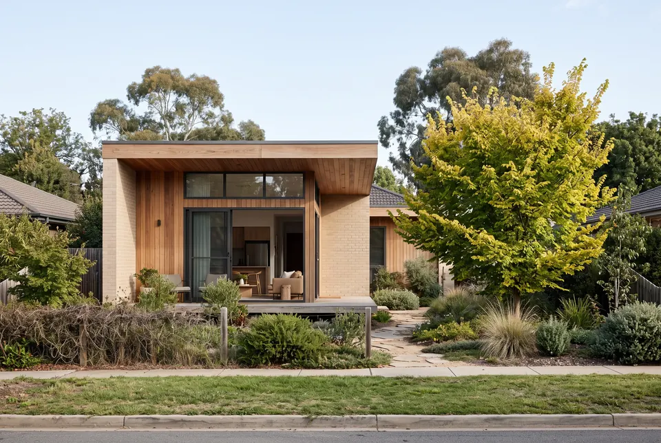 Ainslie secondary residence in pale brick and spotted gum with a golden elm